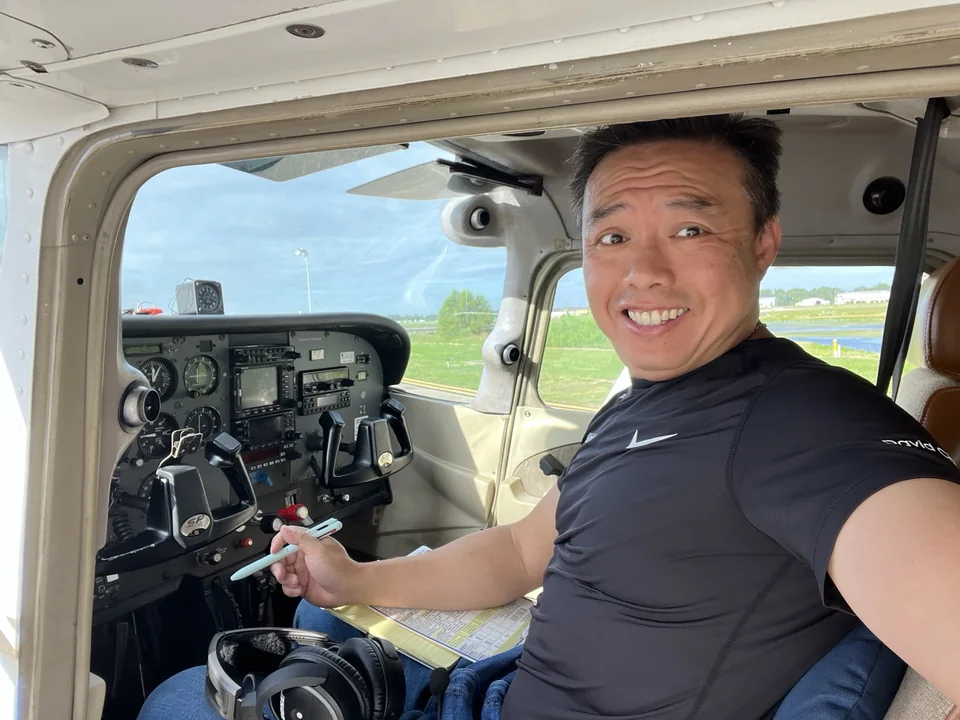 Dave smiling in an aircraft cockpit, with the instrument panel beside him.